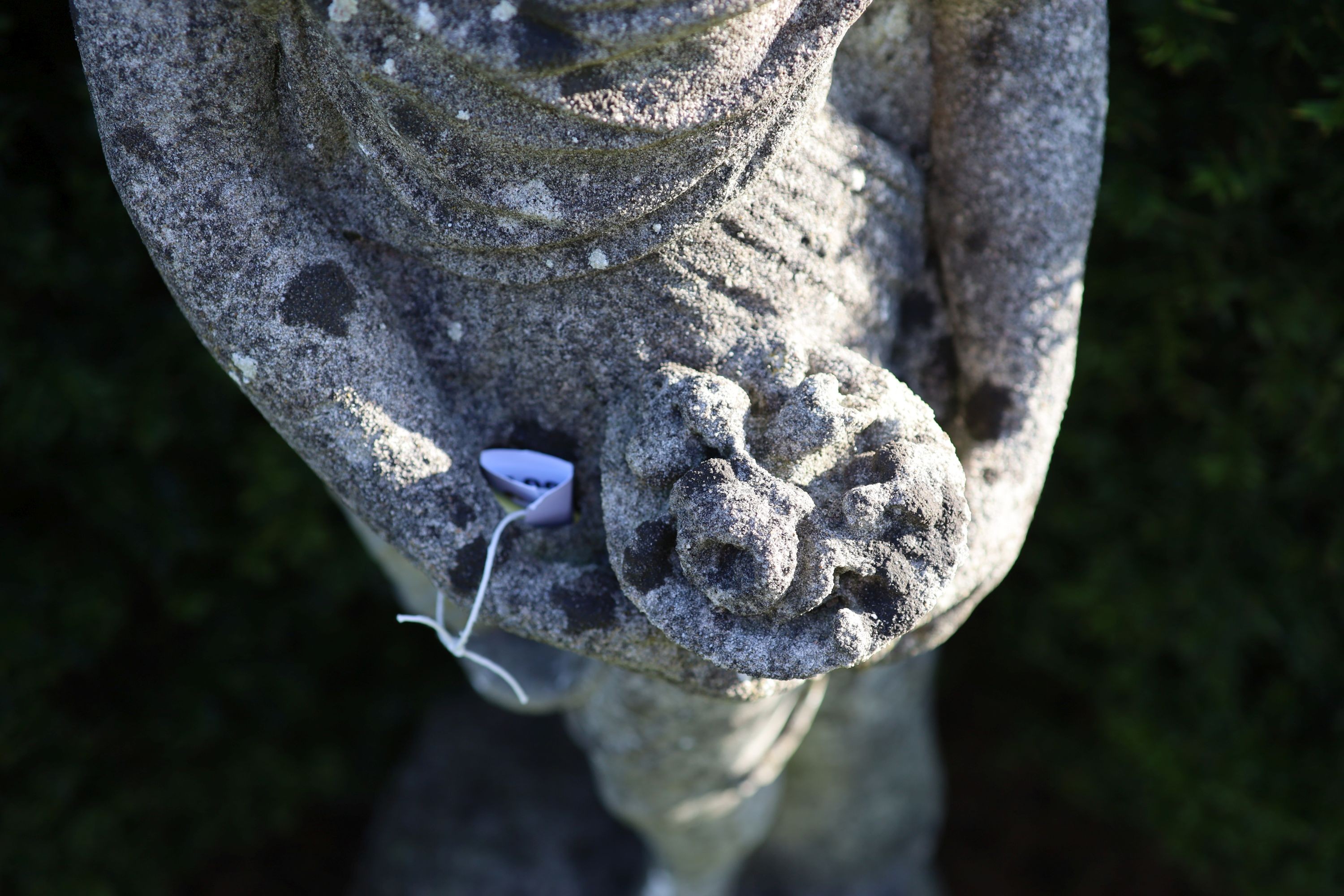 A reconstituted stone garden statue modelled as Flora, on turned socle, height overall 154cm